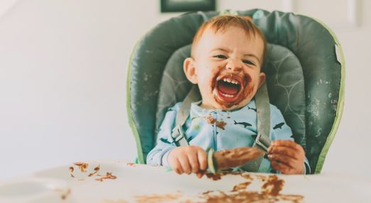 Boy eating in high chair