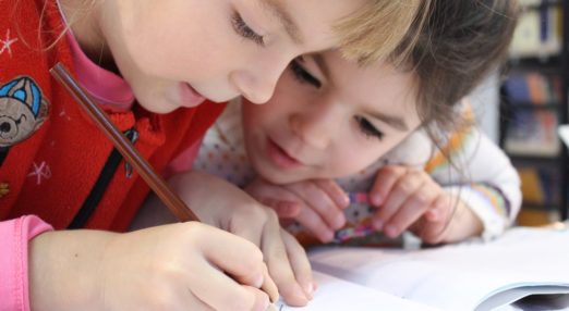 Girls writing in book