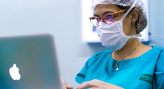 Doctor in mask on laptop