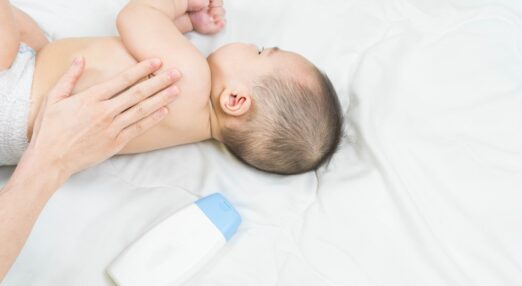 Baby having cream applied