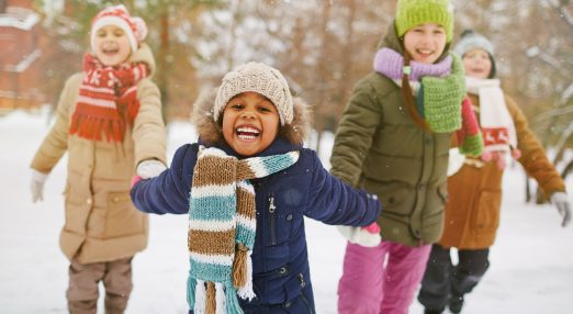 Children playing outside in the snow