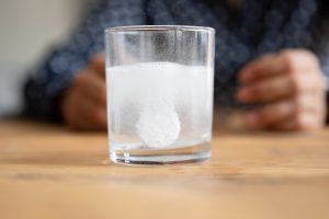 Effervescent tablet dispersing in glass of water