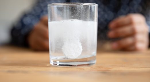 Effervescent tablet dispersing in glass of water